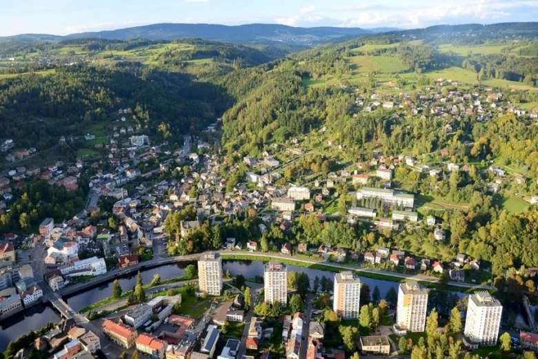 Pohled z letadla na město Železný Brod v zeleném údolí.